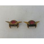 A pair of Aeroshell lapel badges.
