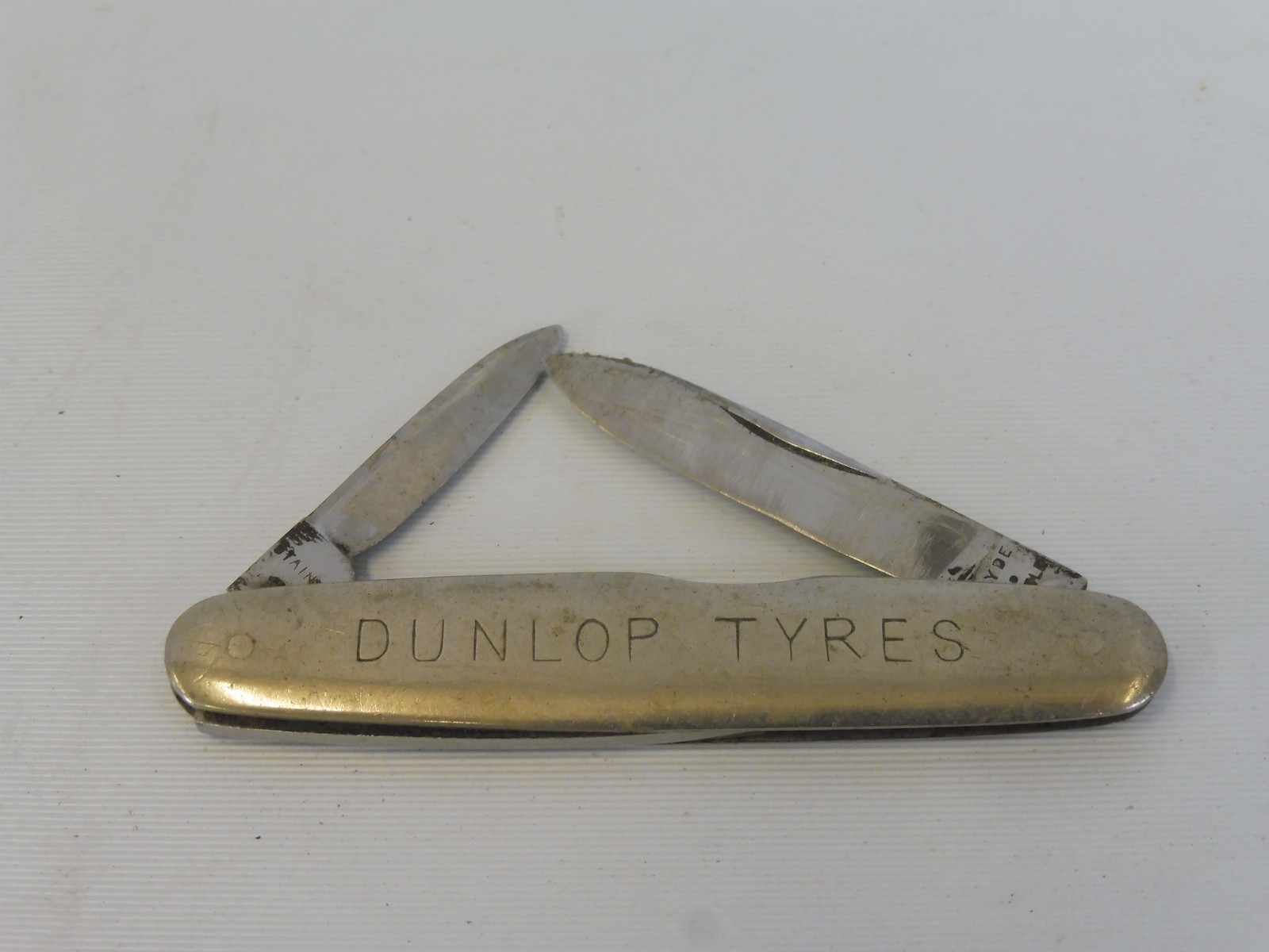 A Dunlop Tyres penknife marked to the reverse: Burns Philp (Southsea) Co. Ltd.