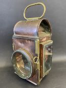 A large copper and brass mounted fire engine lamp.