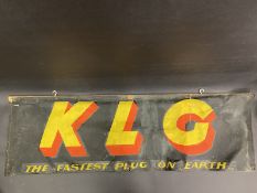 A KLG 'The Fastest Plug on Earth' rectangular banner on a hanging timber, 46 x 14".