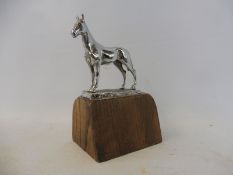 A Desmo car accessory mascot in the form of a standing horse, display base mounted.
