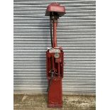 A Bowser hand operated petrol pump with rubber hose and bronze nozzle.