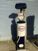 A Bowser hand operated petrol pump, restored in Esso livery, with rubber hose and nozzle.