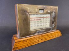 An early oak and silver plated desk-top calendar advertising Bentley motor cars.