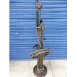 A Godwin hand-operated petrol pump with rubber hose and bronze nozzle.