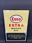 An original Esso Extra Motor Oil advertisement, framed and glazed, 21 1/2 x 31 1/2".