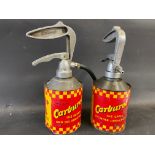 Two Carburol UCL dispensing guns, the tins having different wording.