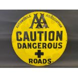 An early AA 'Caution Dangerous Roads' circular enamel sign with many patches of older restoration,