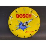 A Bosch spark plugs circular plastic battery operatied wall clock, 12" diameter.