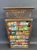 A Lumax British Bulbs wall mounted single door dispensing cabinet with contents.
