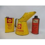 A Shell Lubricants half gallon measure, a Shell quart can plus a Delco shock absorber oil quart can.