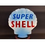 A blue Super Shell glass petrol pump globe by Hailware, bright lettering, two minor chips to rim