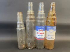 Four assorted Esso oil bottles.