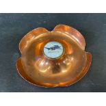 A copper ashtray with an enamel disc inset, advertising Blue Bird Petrol.