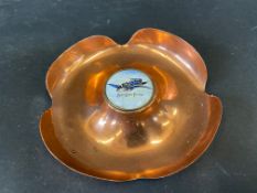 A copper ashtray with an enamel disc inset, advertising Blue Bird Petrol.