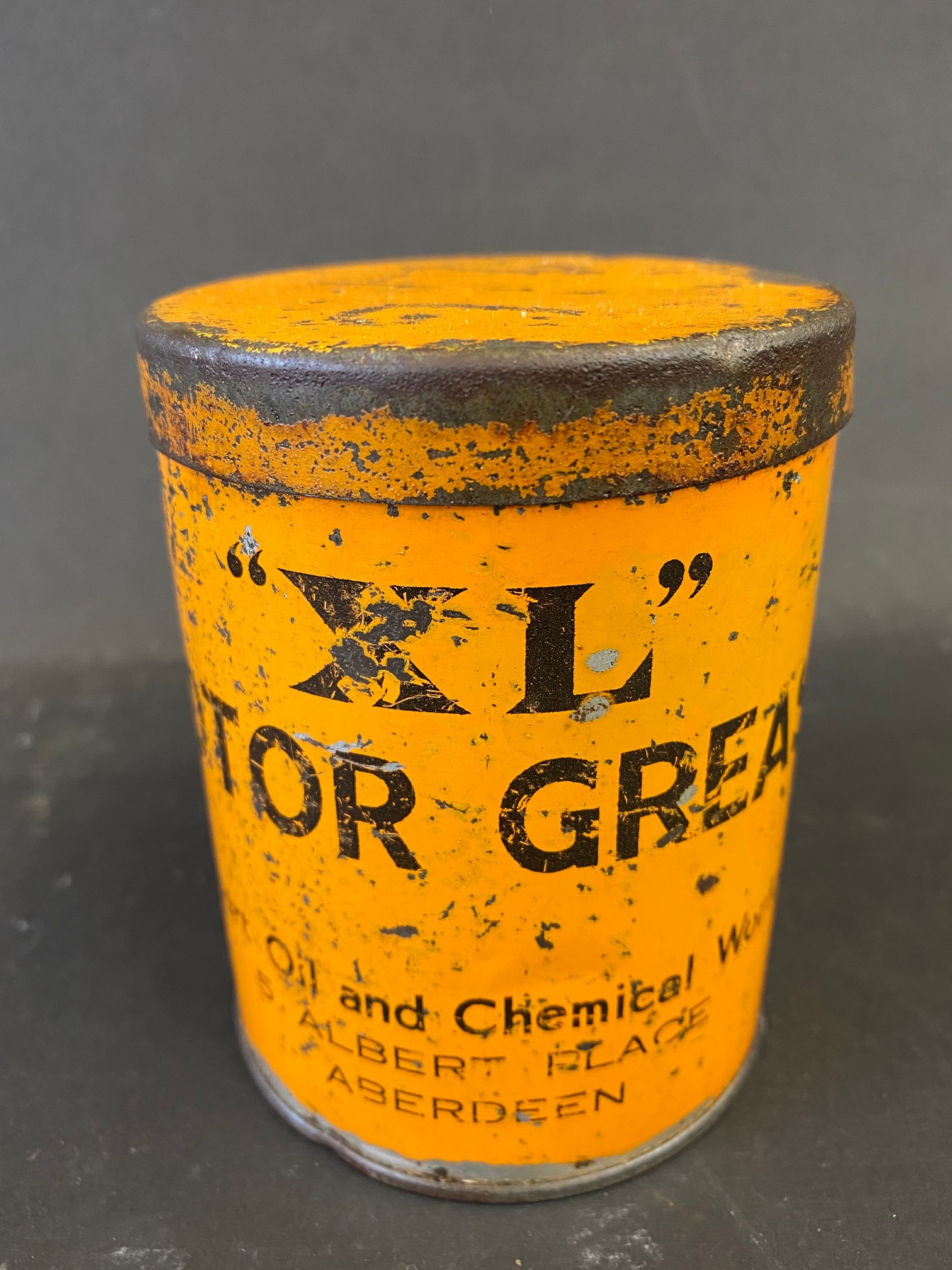 An XL Motor Grease tin.