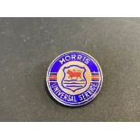 A Morris Universal Service lapel badge.