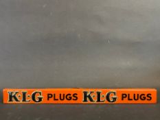 A K.L.G. Plugs embossed tin shelf strip, in good condition.