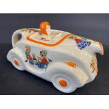 An Art Deco ceramic teapot in the form of a streamlined racing car decorated with nursery scenes.