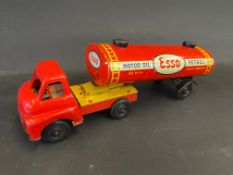An Esso tinplate model of an articulated petrol tanker bearing Esso livery.