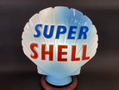 A blue Super Shell glass petrol pump globe by Hailware, fully stamped underneath.