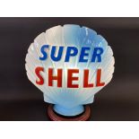 A blue Super Shell glass petrol pump globe by Hailware, fully stamped underneath.