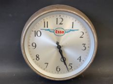 A circular wall clock with Esso advertising to the dial, 11" diameter.