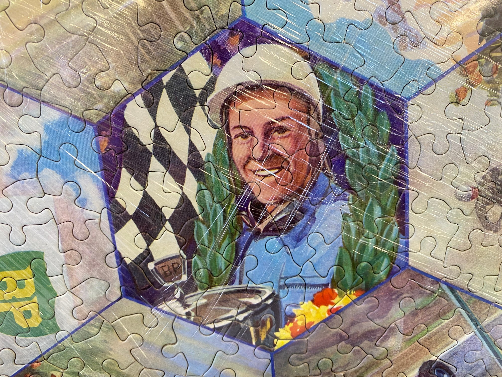 An unusual BP circular motoring themed jigsaw puzzle depicting Stirling Moss to the centre, - Image 2 of 2