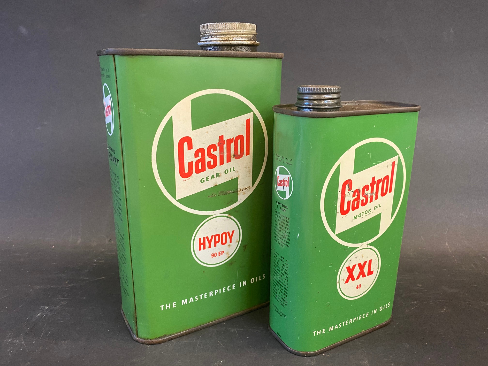 A Castrol Gear oil quart can plus a Motor Oil XXL grade pint can.