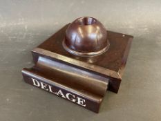 A Delage bakelite style pen holder and inkwell, possibly a salesman's desk piece in a dealership.