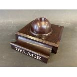 A Delage bakelite style pen holder and inkwell, possibly a salesman's desk piece in a dealership.