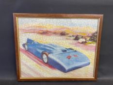 A framed and glazed jigsaw of Bluebird, the landspeed record breaking car, 21 x 17".