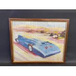 A framed and glazed jigsaw of Bluebird, the landspeed record breaking car, 21 x 17".