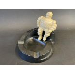 A Michelin bakelite ashtray surmounted by a seated Mr. Bibendum.