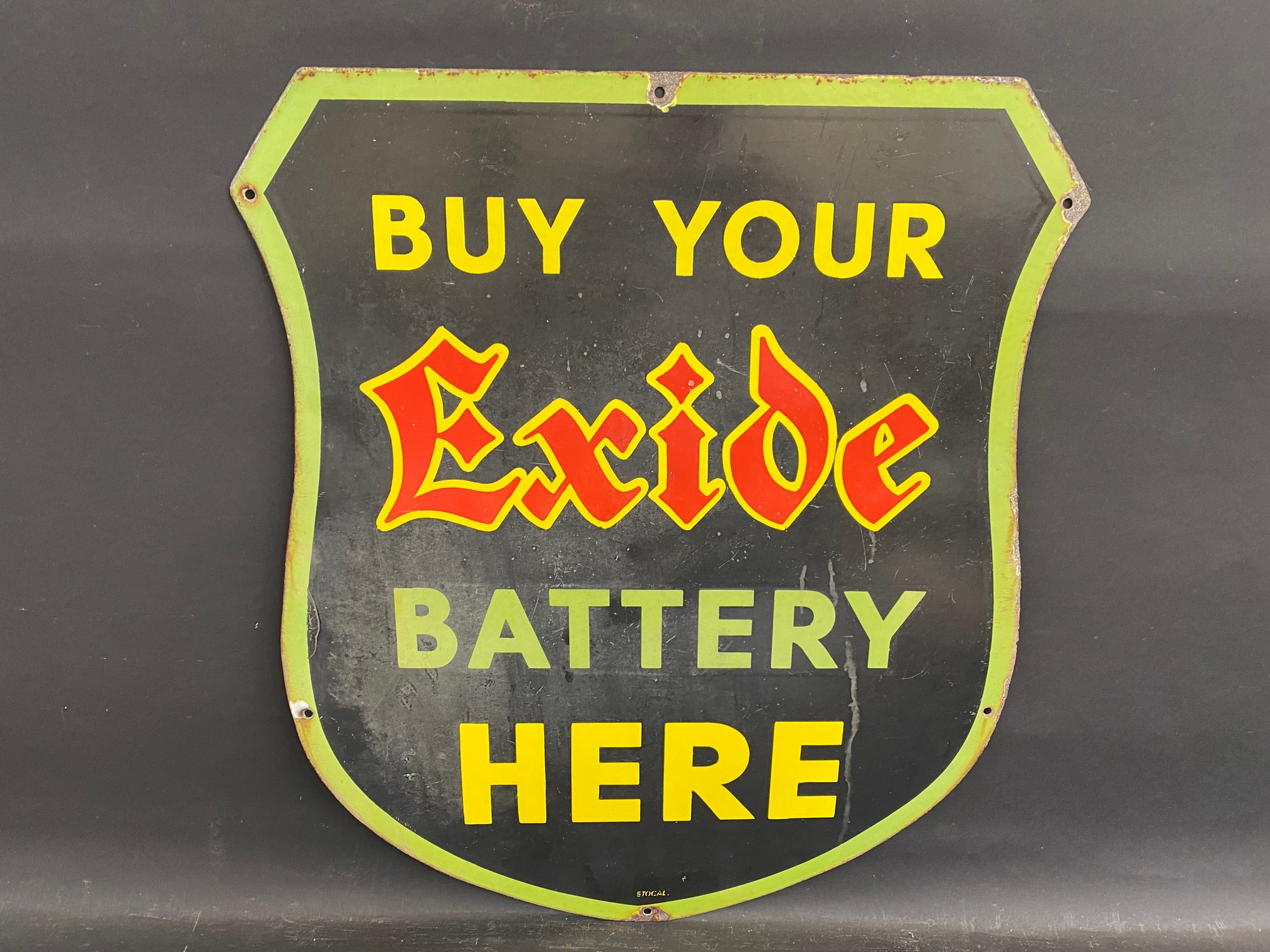 An Exide Battery shield-shaped enamel sign by Stocal, 21 x 24".