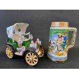 A decorative bicycle tankard and an Edwardian ceramic motor car.