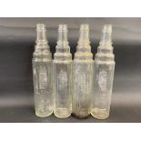 Four Essolube quart glass oil bottles.