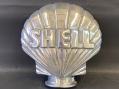 A contemporary polished aluminium clam Shell sign, 16 1/2 x 16 1/2.