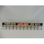 An Atlas fan belts hanging rack with tin advertising sign to the front, 38" long.