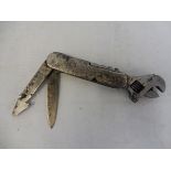 An unusual early Shell petrol motor oil company accessory multi tool which includes an adjustable