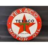 A Texaco Motor Oil circular enamel sign with some professional restoration, mounted on a board,