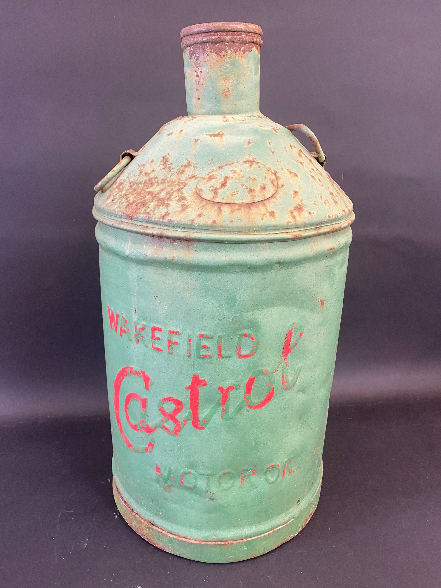 A Wakefield Castrol Motor Oil conical five gallon can with embossed lettering.