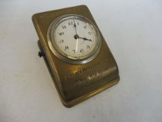 A rare unusual Miller Tyres of Glasgow clock set within a brass metal clip.