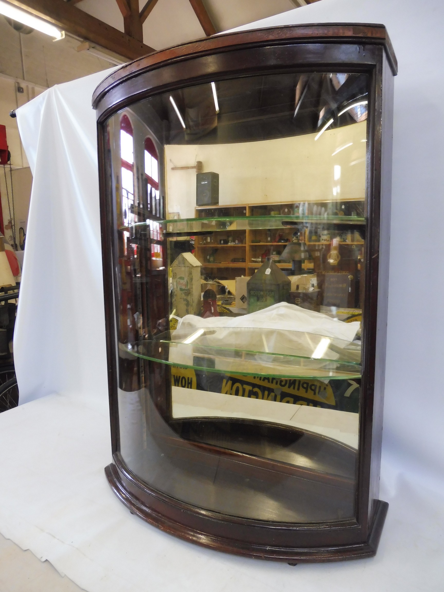 A bow glass fronted rear opening display cabinet with two glass shelves, 24 3/4" w x 35 1/2" h x