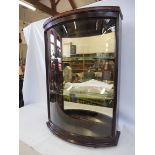 A bow glass fronted rear opening display cabinet with two glass shelves, 24 3/4" w x 35 1/2" h x