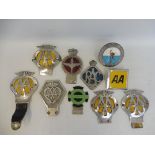 A group of car badges including an AA Commercial badge no. V191021, a parachute corps badge by Gaunt