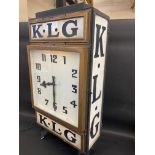 A rare and highly original K.L.G. garage advertising double sided clock with original dials and milk