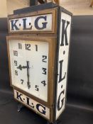 A rare and highly original K.L.G. garage advertising double sided clock with original dials and milk
