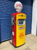 A well restored American Bennett electric petrol pump in Shell livery surmounted by an original