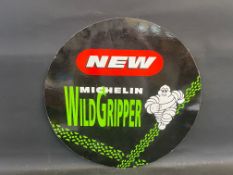 A Michelin 'Wild Gripper' circular cardboard double sided advertiisng sign, 24 1/2" diameter.